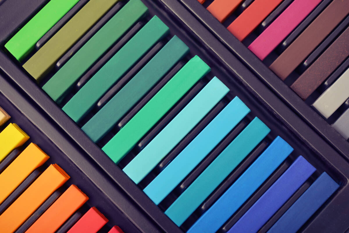 Multicolored artist's pastels in box, top view