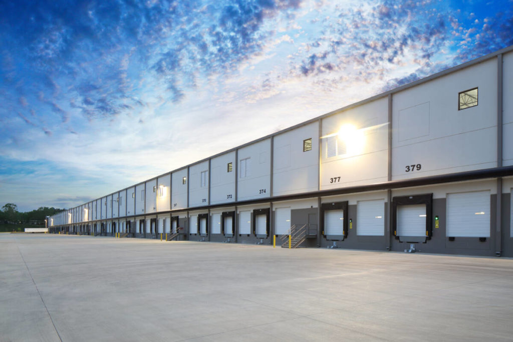 Exterior of modern distribution centre warehouse at sunrise