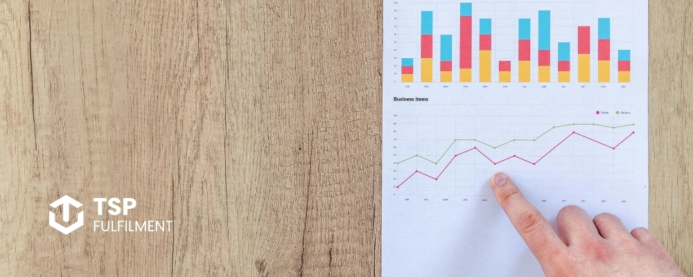 A finger pointing at two graphs on a single sheet of paper
