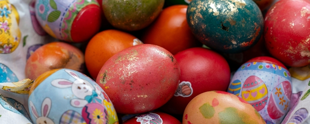 Several decorated eggs in a basket.